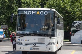 "n"nPicture of a Nomago coach with its logo on a platform in Ljubljana bus station, Slovenia. Nomago is a Slovenian multinational public transport company specialized in bus offering as well travel agency services.