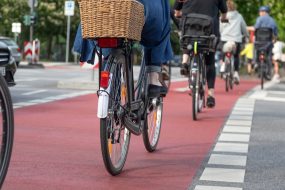 cyclists cross road on red bike crossing