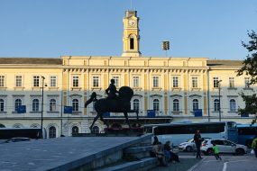 Ljubljana, Slovenia - November 8, 2018:  Landscape and buildings in the immediate vicinity of bronze equestrian statue of Rudolf Maister that stands in a park at Liberation Front Square in Ljubljana.